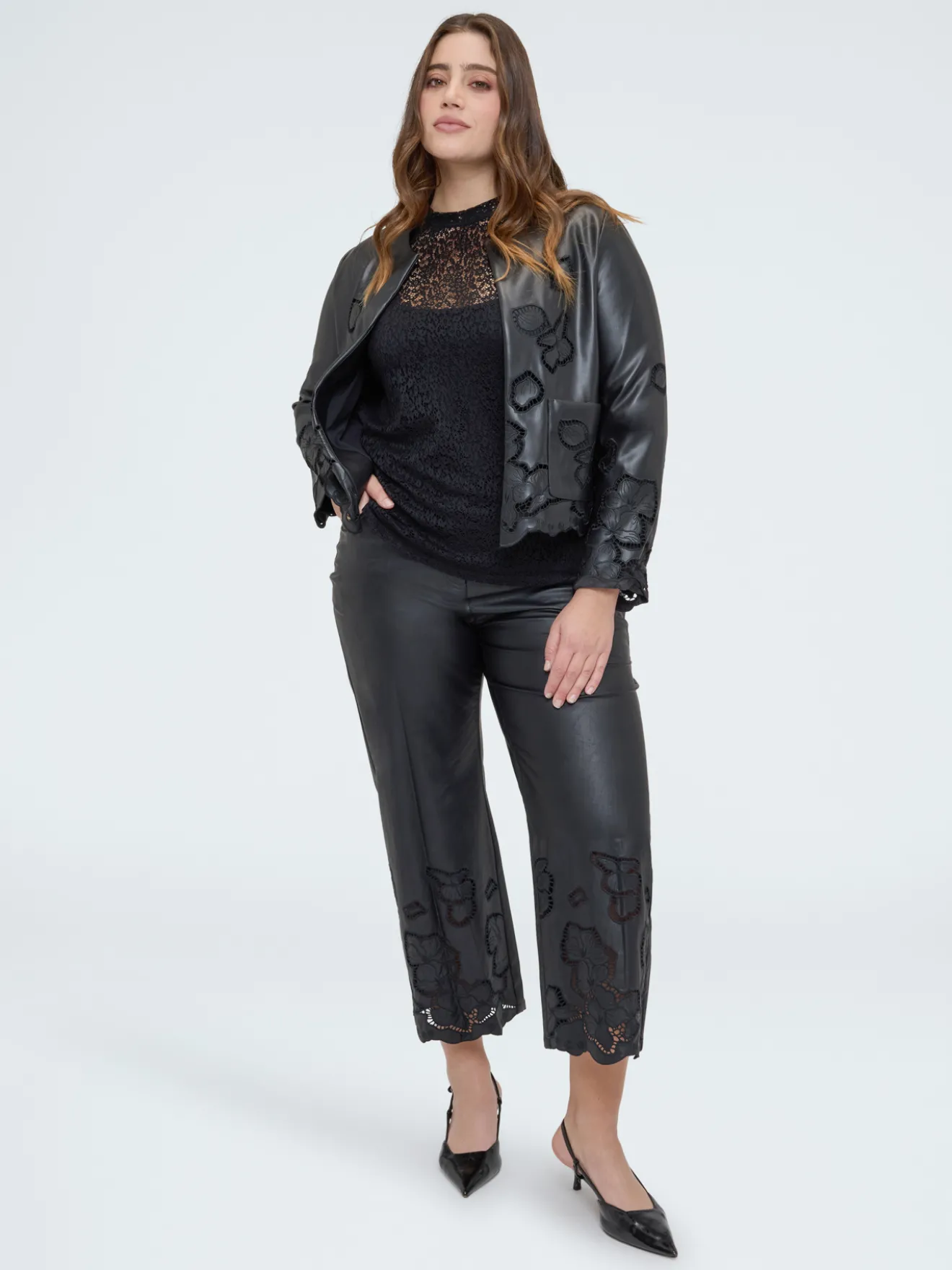 Pantaloni cropped in tessuto spalmato con motivi floreali
